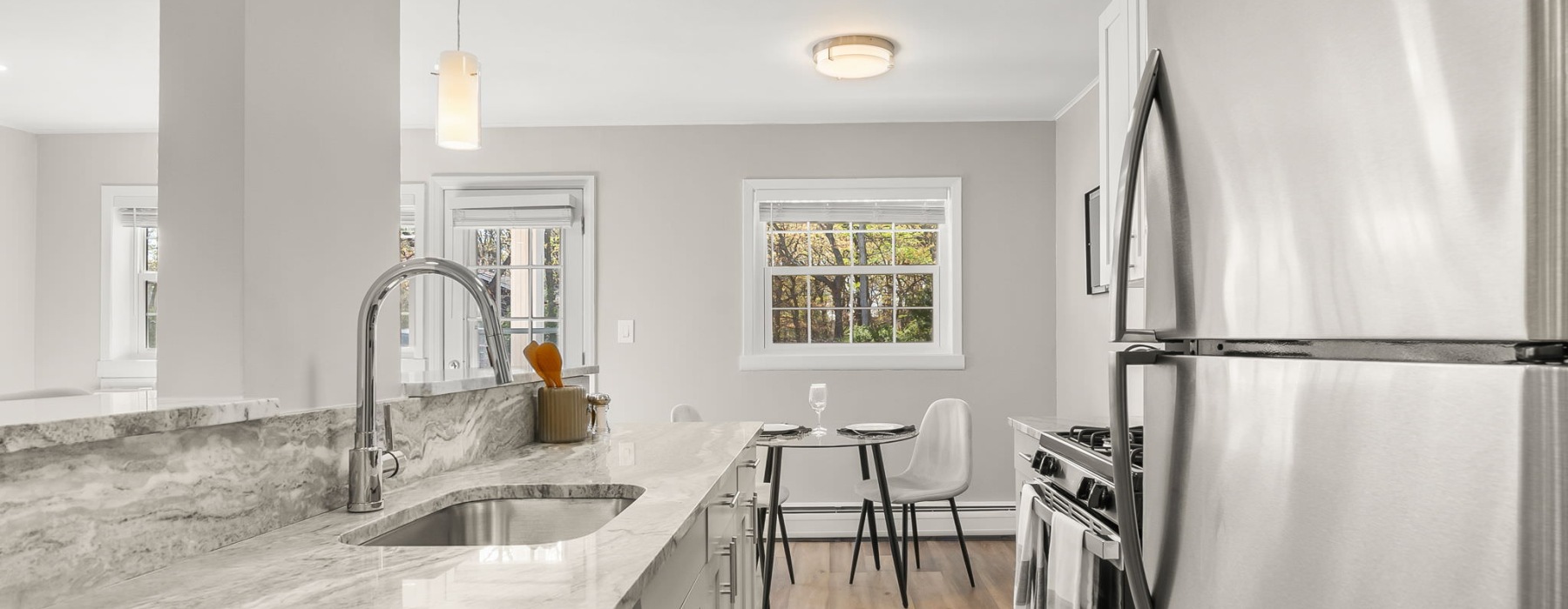 kitchen with stainless steel appliances and dining room in view