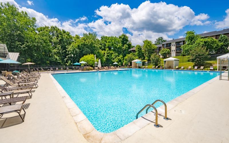 a swimming pool with chairs around it